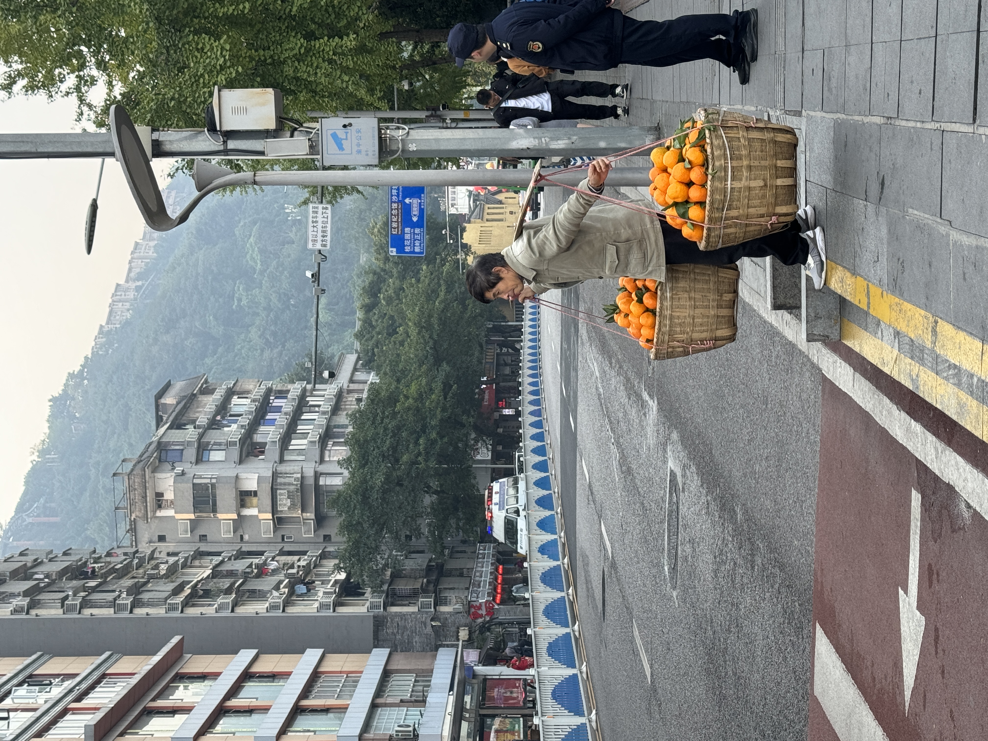 man carrying oranges